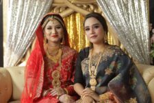 women in traditional clothes sitting indoors